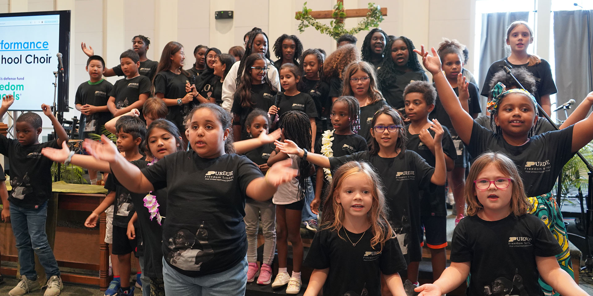 A group of students sing at a Purdue Freedom School event