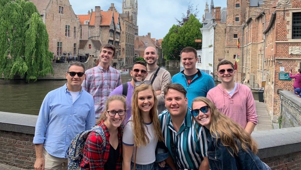 A group of study abroad participants in front of European architecture.