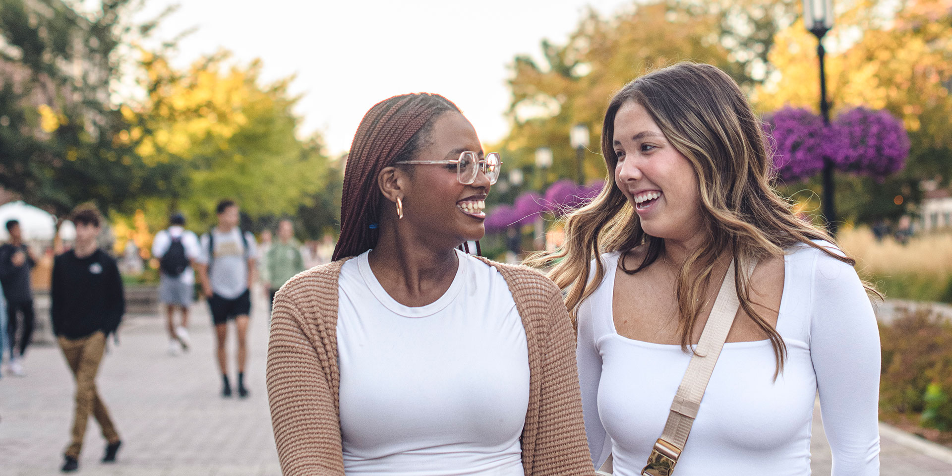 Two female Purdue University students walk through campus talking.