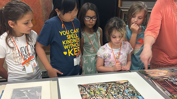 Students at GER2I's Super Summer program via artwork on a table