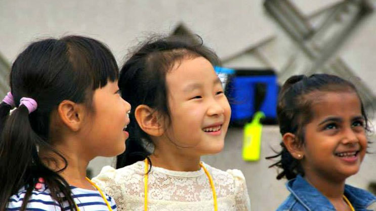 A group of Super Saturday students watches an instructor