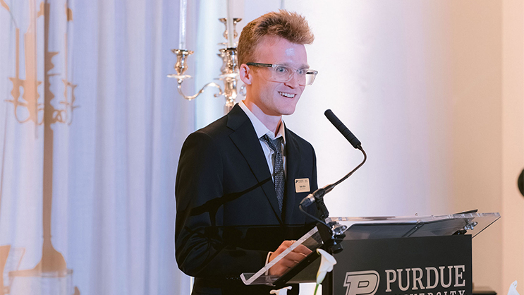 Nate Albin making a speech at a podium.