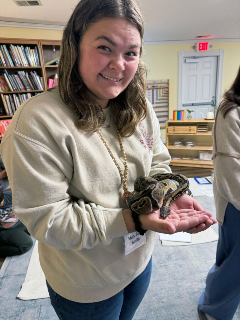 Purdue student Maggie Bowes holding a snake.