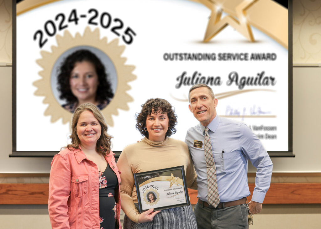 Dr. Juliana Aguilar holding a certificate. Standing with her are Jennifer Smith and Phillip VanFossen.