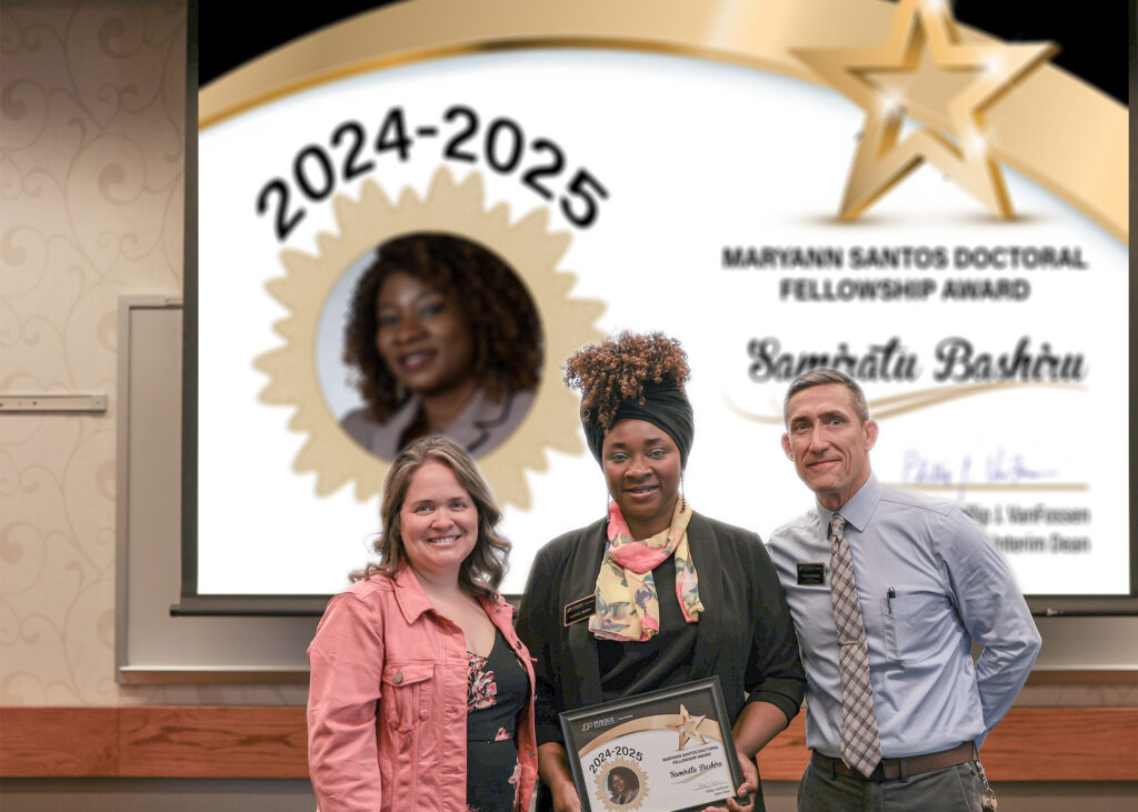 Samiratu Bashiru holding a certificate. Standing with her are Jennifer Smith and Phillip VanFossen.