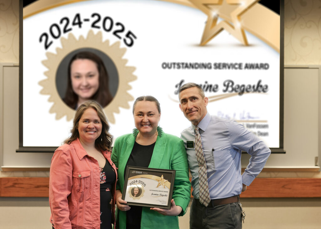 Dr. Jasmine Begeske holding a certificate. Standing with her are Jennifer Smith and Phillip VanFossen.