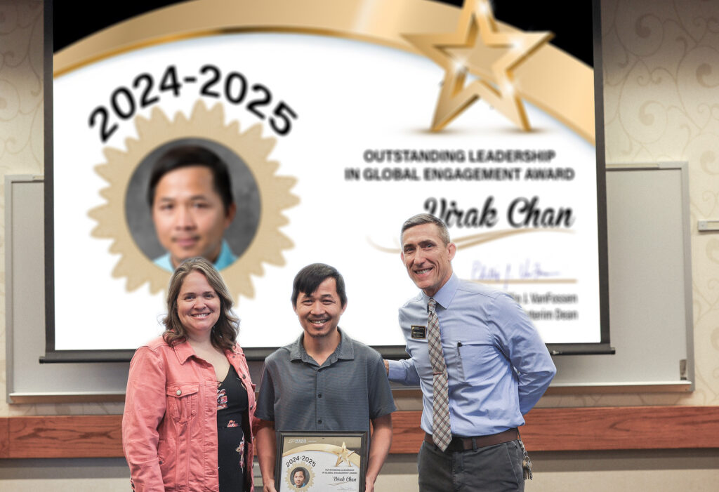 Dr. Virak Chan holding a certificate. Standing with him are Jennifer Smith and Phillip VanFossen.