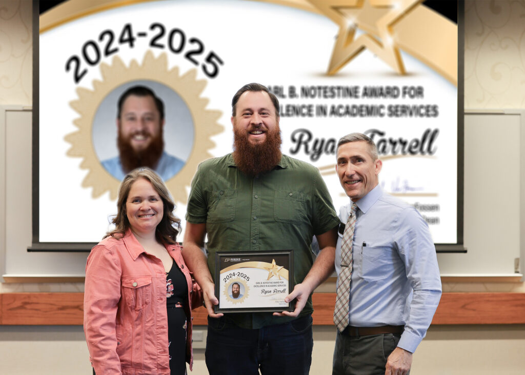 Ryan Farrell holding a certificate. Standing with him are Jennifer Smith and Phillip VanFossen.