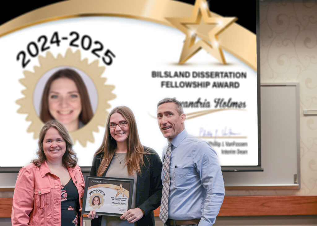 Alexandria Holmes holding a certificate. Standing with her are Jennifer Smith and Phillip VanFossen.
