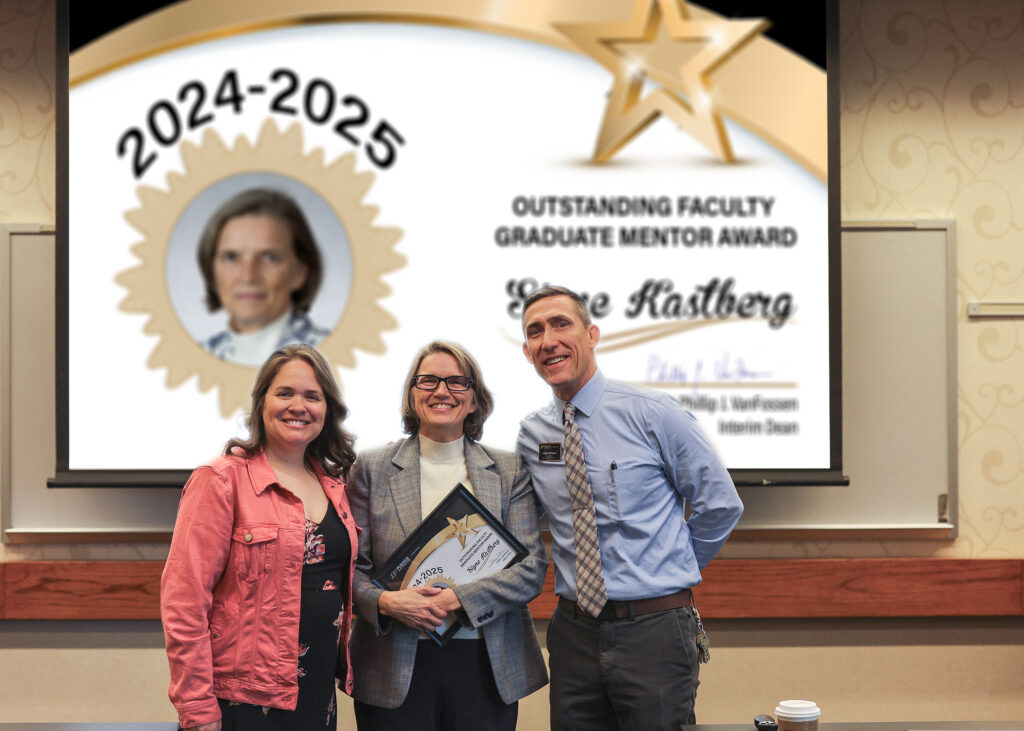 Dr. Signe Kastberg holding a certificate. Standing with her are Jennifer Smith and Phillip VanFossen.