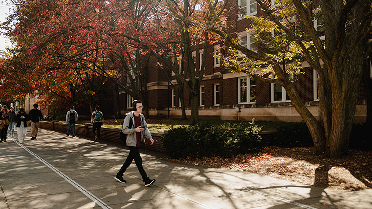 A student walks through Purdue University's campus