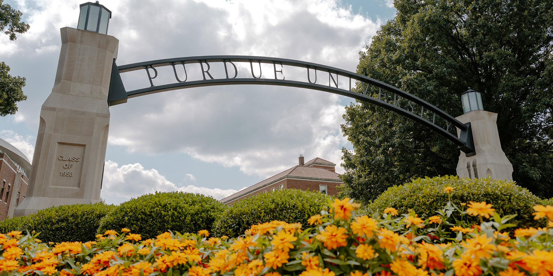 A stone and wrought iron arch that says 