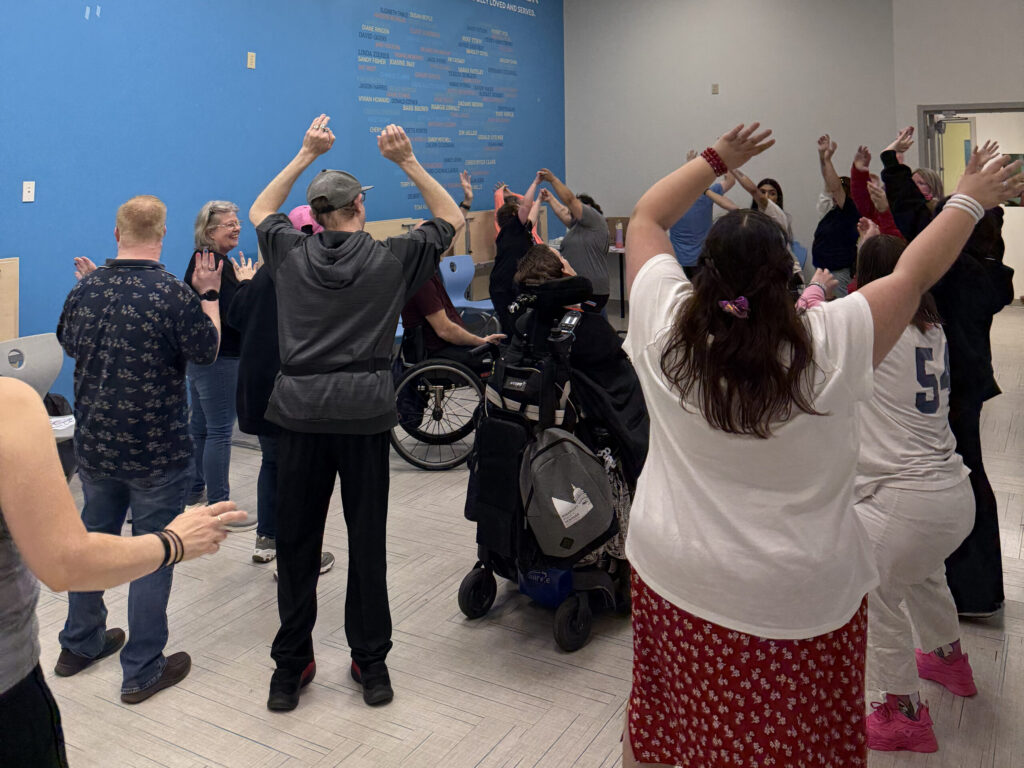 Scheuneman, Laukkanen, and Hernandez lead adult participants in a movement dance activity at Wabash Center