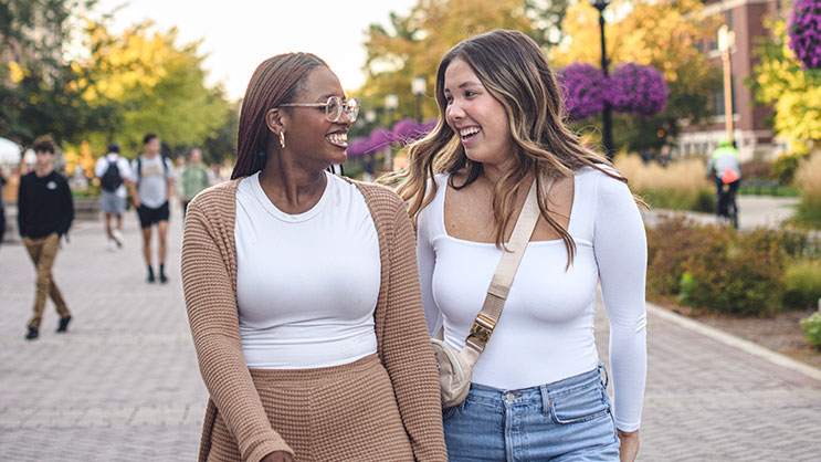 Two Purdue University students walk through campus