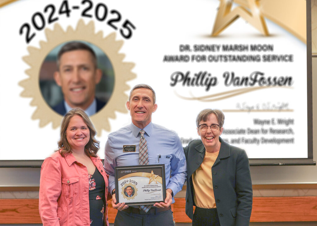 Phil VanFossen holding a certificate.