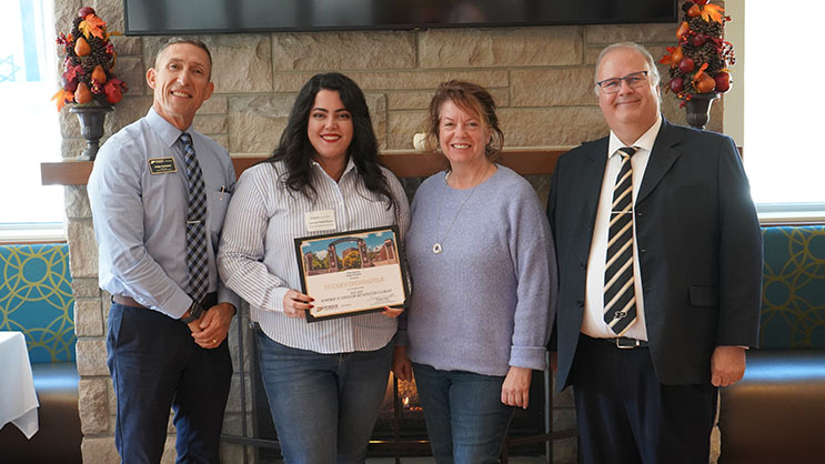 Fatemeh (Emma) Dadashipour holding a certificate. She is surrounded by Phil VanFossen, Jennifer Richardson, and Wayne Wright.