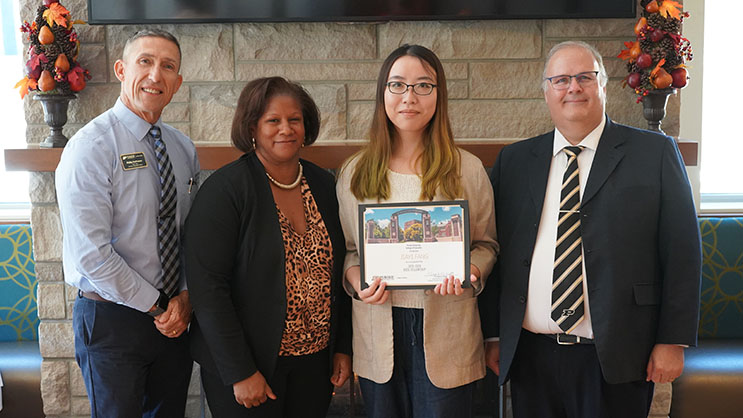Jiayi Fang holding a certificate. She is surrounded by Phil VanFossen, Chrystal Johnson, and Wayne Wright.