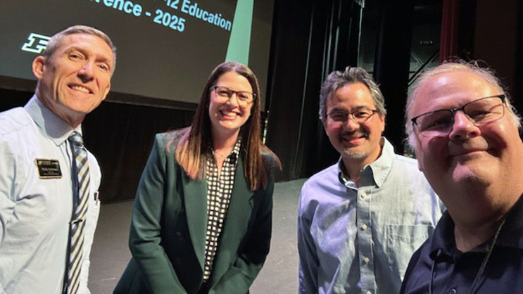 A selfie on stage of Phil VanFossen, Kate Maxwell, Bill Watson, and Wayne Wright.