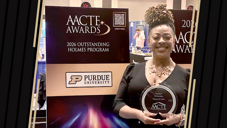 Brittne Paramore holding an award and smiling.
