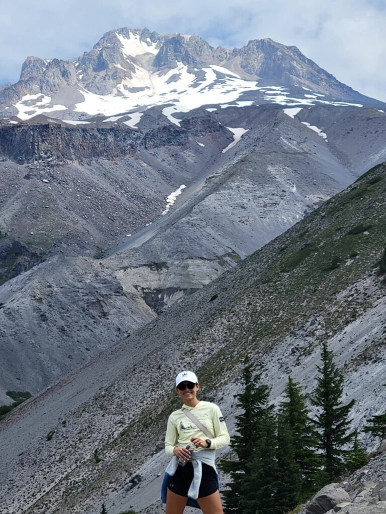 Alison Warren in front of a vast mountainside.