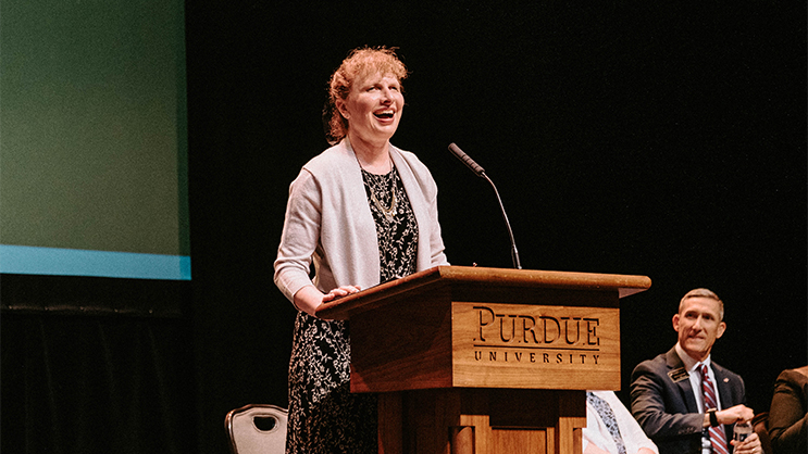 Kathy Nimmer speaking at a podium.