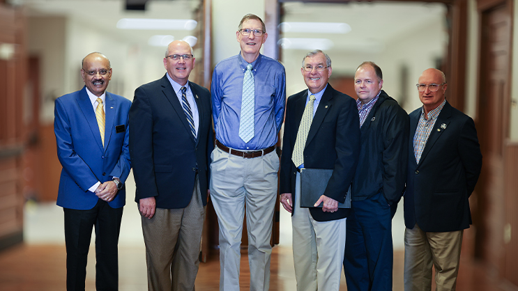 B. Allen Talbert standing next to five colleagues.