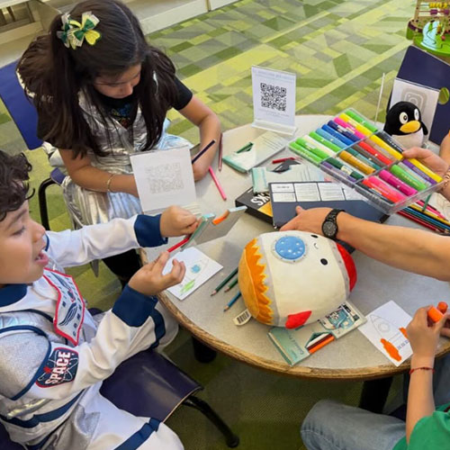 Children work on a craft about astronauts after El Rincón Bilingüe storytime at the library