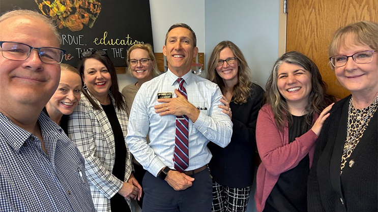 Dean Phil VanFossen surrounded by seven of his colleagues.