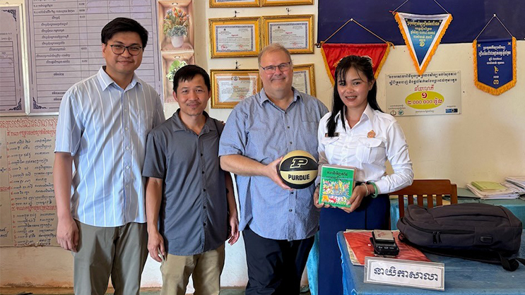 Panha Song, Virak Chan, Wayne Wright, presenting small tokens of appreciation to the principal of one of the multilingual schools in NE Cambodia.