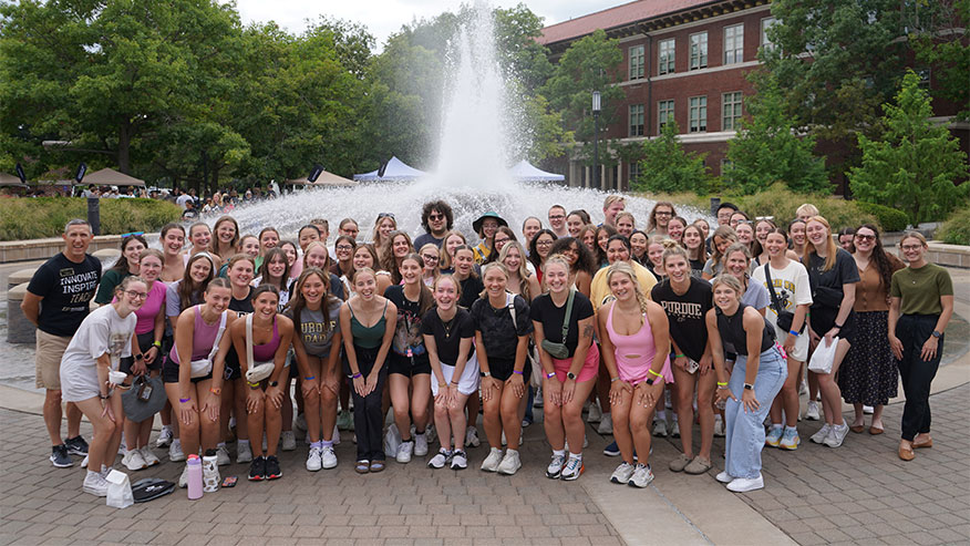 Dean VanFossen standing in front of a fountain with College of Education faculty, staff, and Boiler Gold Rush participants.