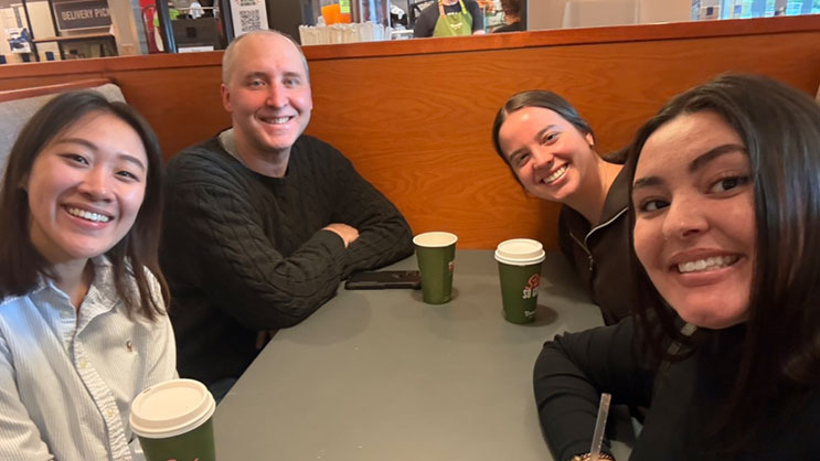 Dr. Eric Deemer with three graduate students.