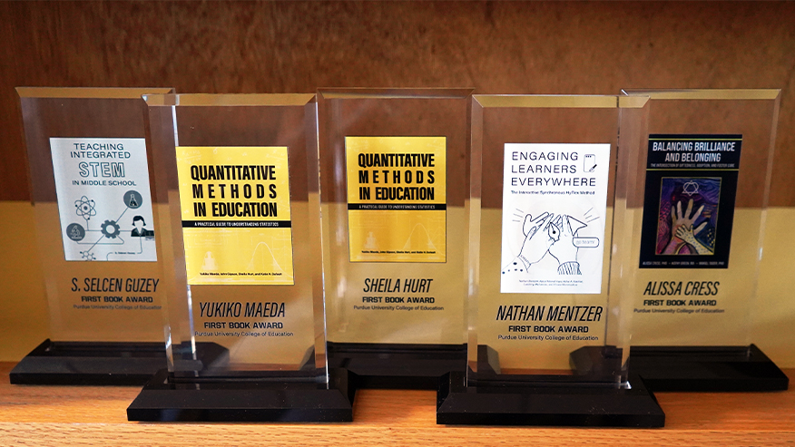 Five "First Book" award plaques for S. Selcen Guzey, Yukiko Maeda, Sheila Hurt, Nathan Mentzer, and Alissa Cress.