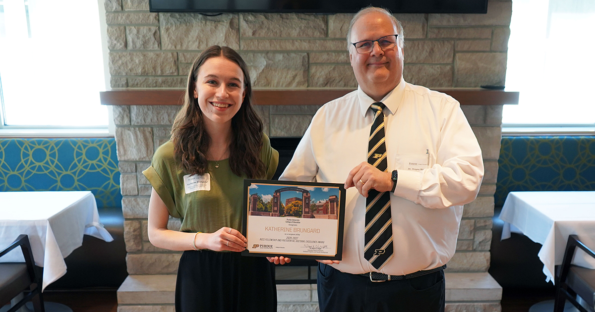 Katherine Brungard and Wayne Wright holding a certificate.