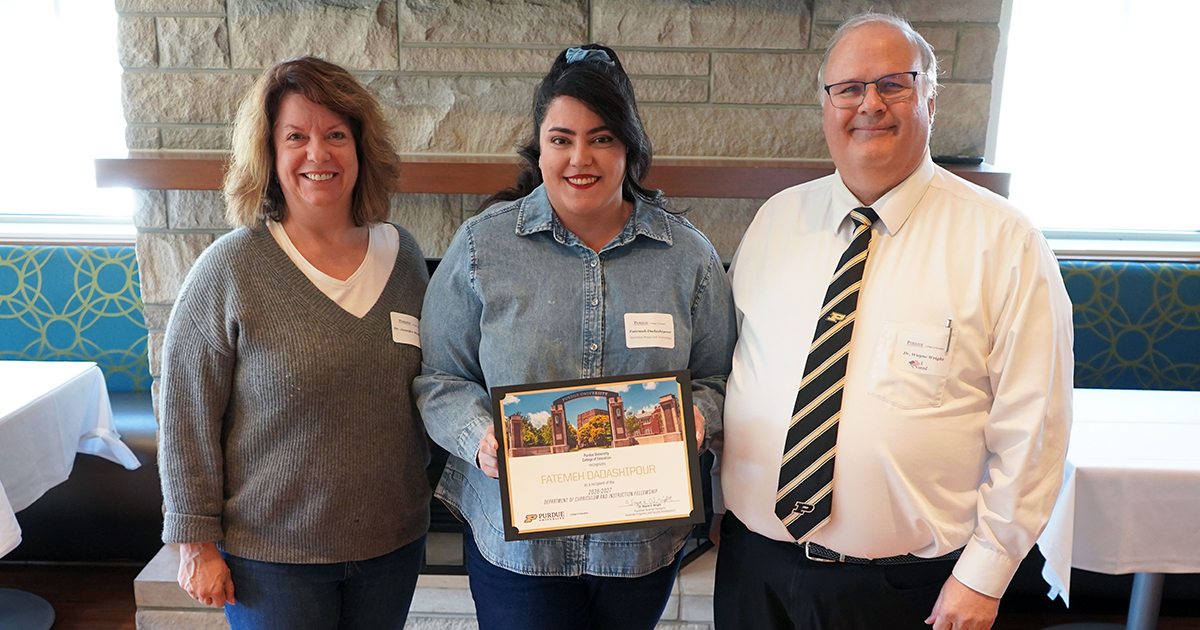 Fatemeh Dadashipour holding a certificate. She is surrounded by Jennifer Richardson and Wayne Wright.