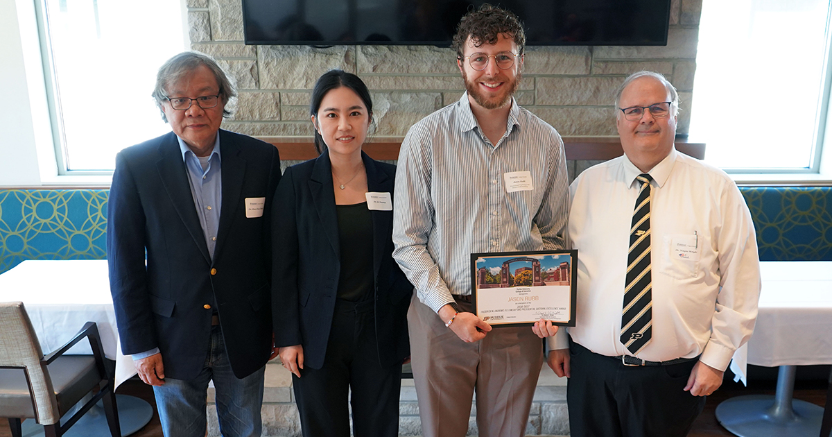 Jason Rubb holding a certificate. He is surrounded by Qi Huang, Hua Hua Chang, and Wayne Wright.