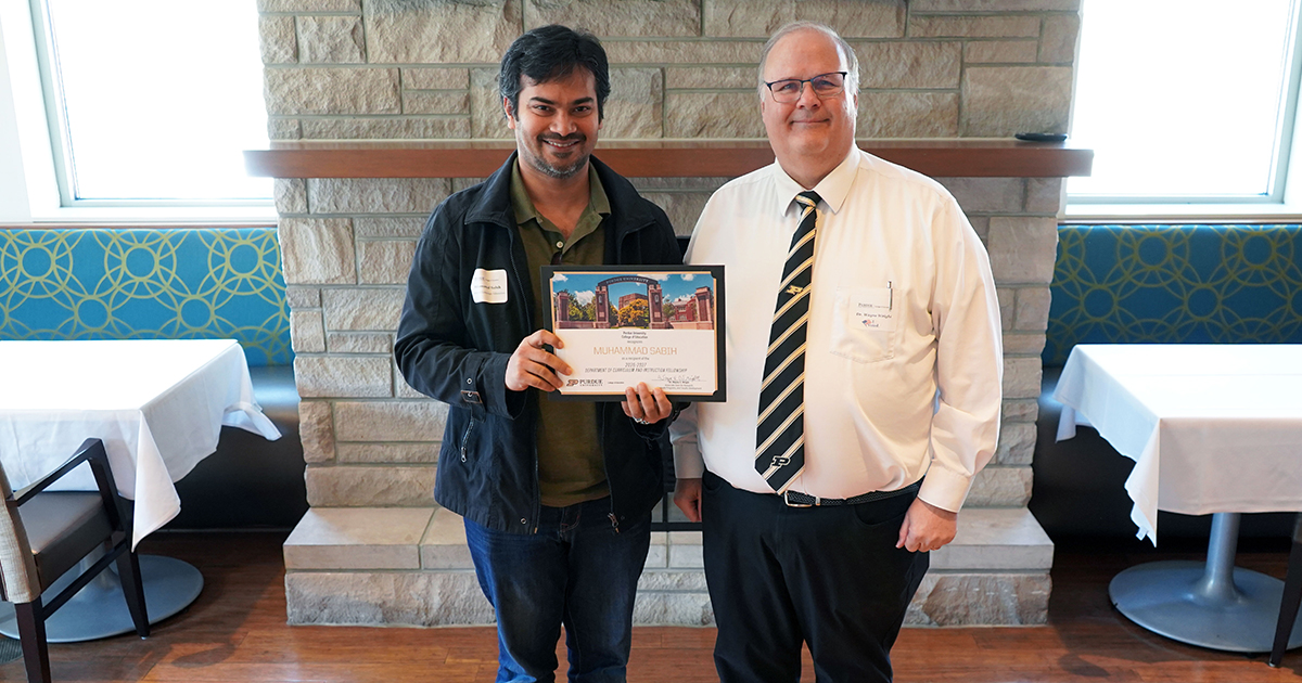 Muhammad Sabih and Wayne Wright holding a certificate.